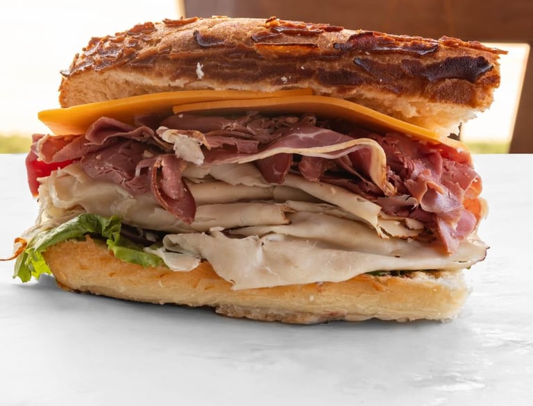 Multi-layered gourmet sandwich with meats and cheese