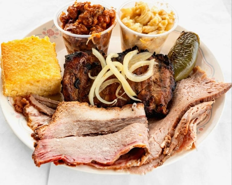 Sliced roasted meats with cornbread and grilled onions